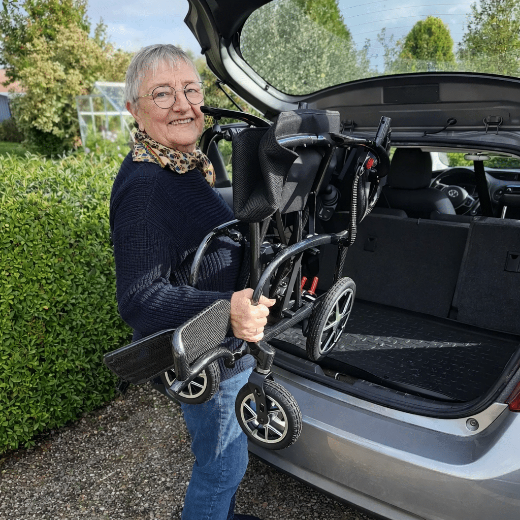 Løfter el kørestol in i bilen